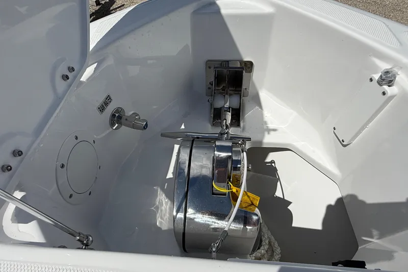 Slide: The Image of Anchor compartment of 2026 Everglades 335 Center Console boat, featuring a winch system. - 11