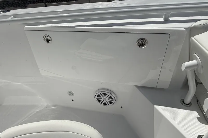 Slide: The Image of 2026 Everglades 335 Center Console boat interior with storage compartment and speaker. - 14