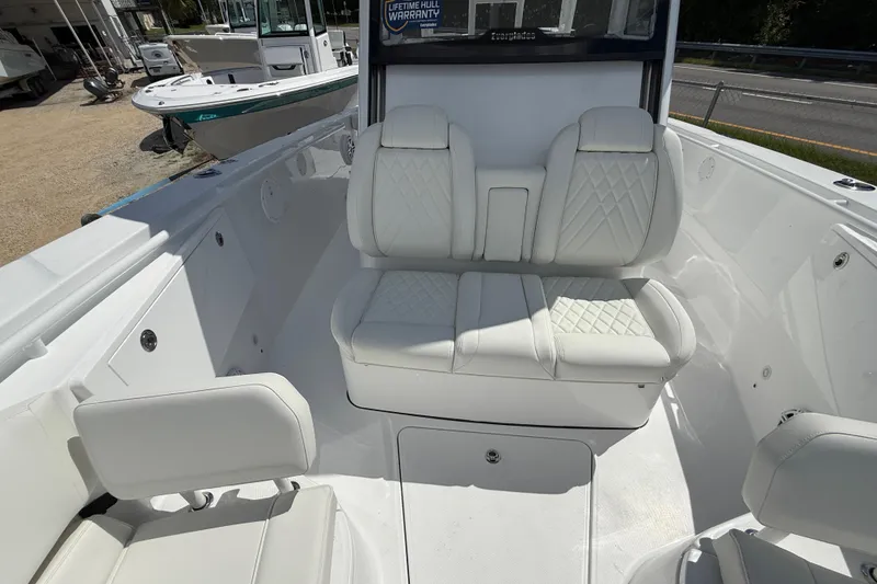 Slide: The Image of 2026 Everglades 335 Center Console boat interior with white cushioned seating. - 16