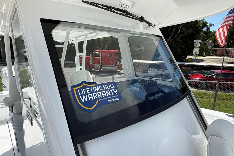 Slide: The Image of 2026 Everglades 335 Center Console boat with lifetime hull warranty sticker. - 17