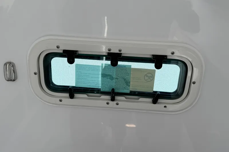 Slide: The Image of Porthole window on 2026 Everglades 335 Center Console boat interior. - 20