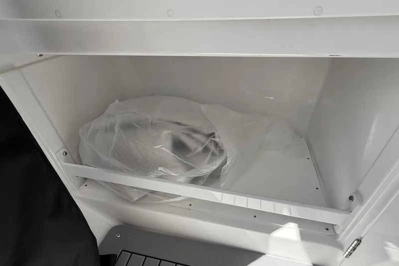 Slide: The Image of Storage compartment of 2026 Everglades 335 Center Console boat, featuring a clean interior. - 22