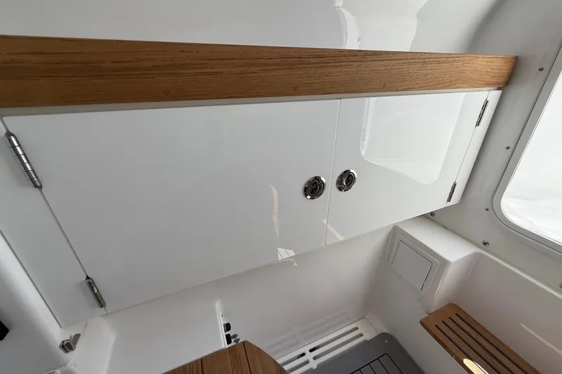 Slide: The Image of Interior of 2026 Everglades 335 Center Console boat with sleek cabinetry design. - 23