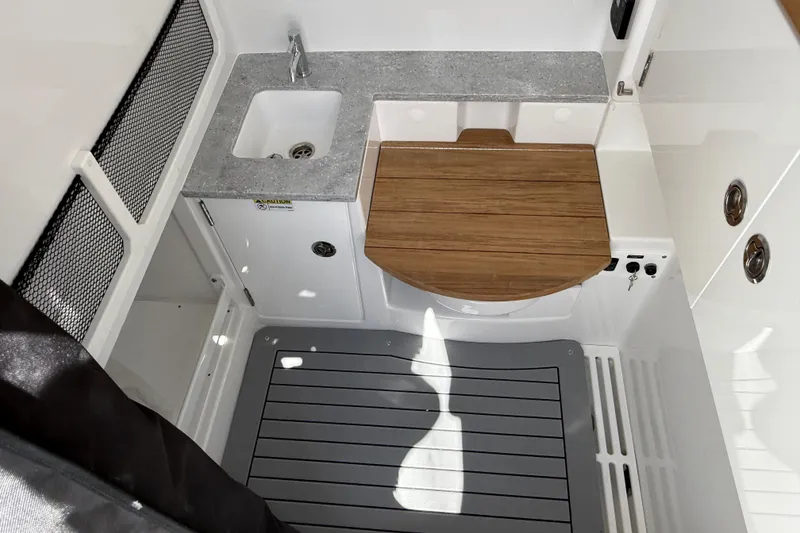 Slide: The Image of 2026 Everglades 335 Center Console interior with sink and wooden countertop. - 24