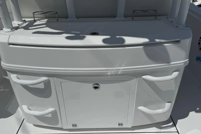 Slide: The Image of 2026 Everglades 335 Center Console boat interior with storage compartments and cup holders. - 35