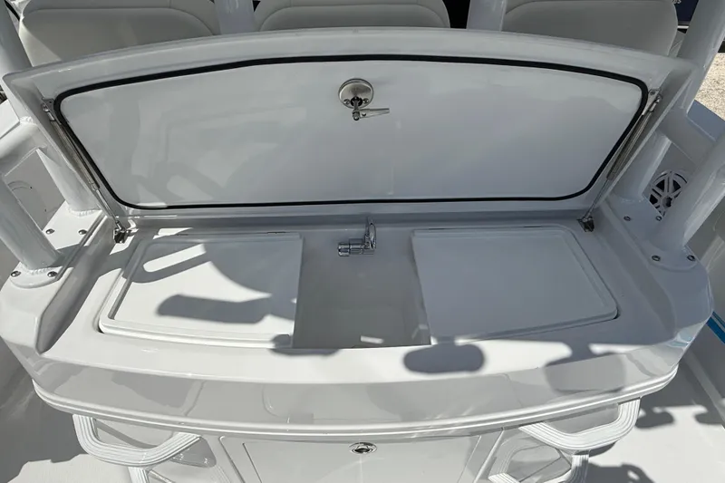 Slide: The Image of 2026 Everglades 335 Center Console boat sink and storage area, open lid view. - 36