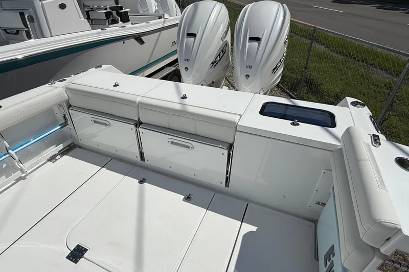 Slide: The Image of 2026 Everglades 335 Center Console boat with dual outboard engines and spacious seating area. - 38