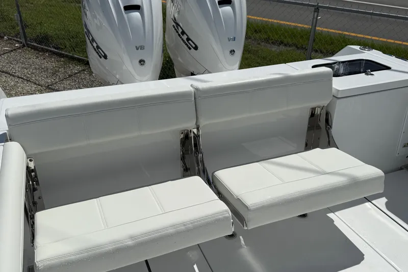 Slide: The Image of 2026 Everglades 335 Center Console boat with white seating and dual outboard engines. - 41