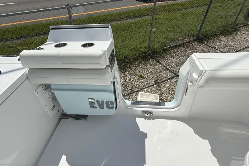 Slide: The Image of 2026 Everglades 335 Center Console boat interior with seating and cup holders. - 42