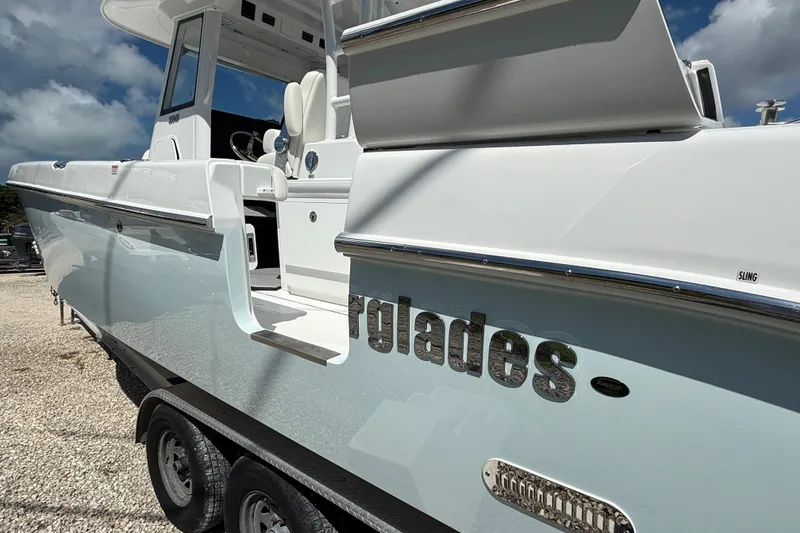 Slide: The Image of 2026 Everglades 335 Center Console boat on trailer under blue sky. - 43