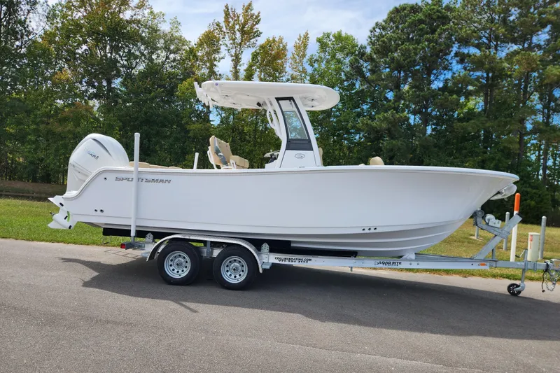 The Image of 2026 Sportsman Heritage 231 Center Console boat on trailer, parked outdoors. - 0