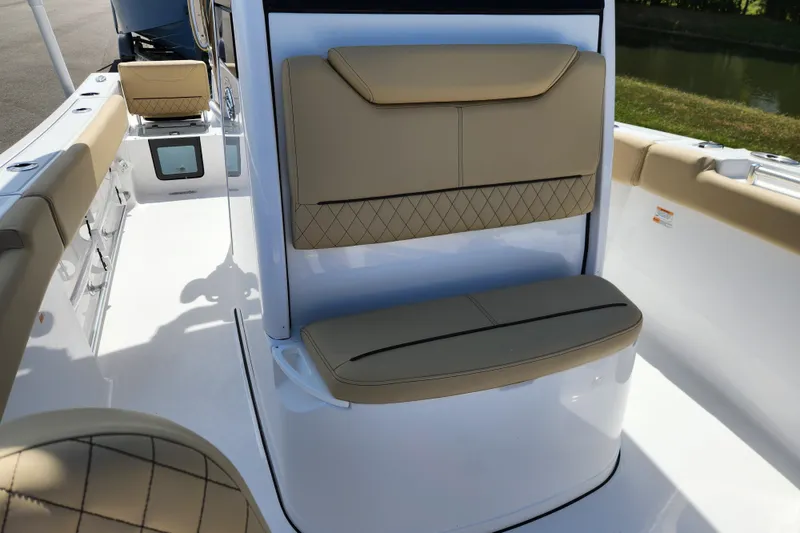 Slide: The Image of 2026 Sportsman Heritage 231 Center Console boat interior with tan cushioned seating. - 12