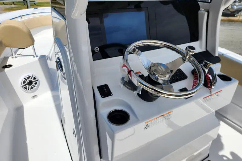 Slide: The Image of 2026 Sportsman Heritage 231 Center Console boat steering wheel and dashboard. - 14