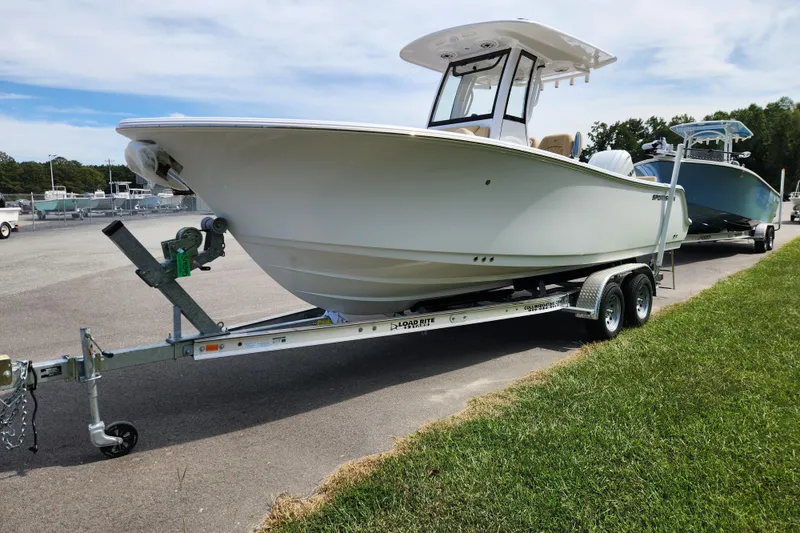 Slide: The Image of 2026 Sportsman Heritage 231 Center Console boat on trailer, parked outdoors. - 6