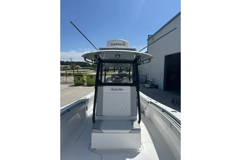Slide: The Image of 2022 Onslow Bay 33 Tournament boat with Garmin equipment, docked outdoors under clear blue sky. - 11