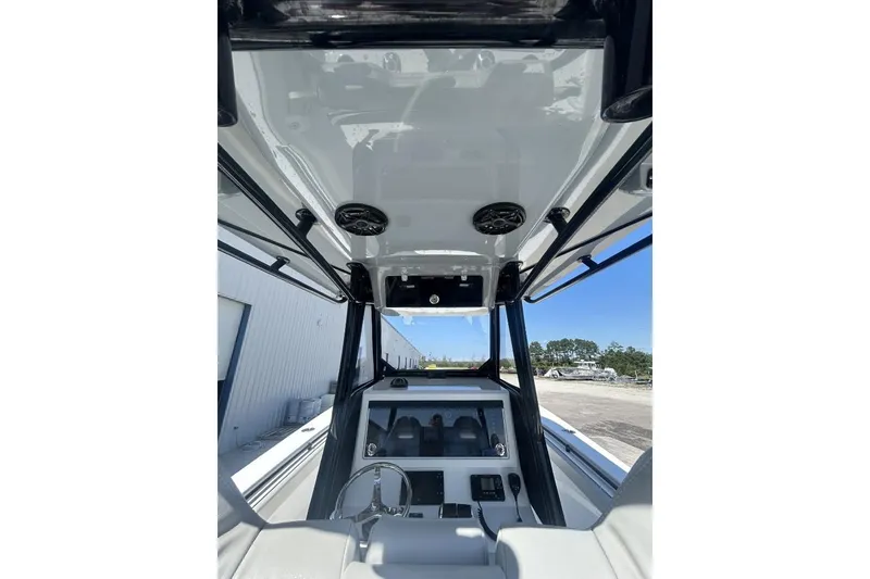 Slide: The Image of 2022 Onslow Bay 33 Tournament boat console with steering wheel and electronics. - 13