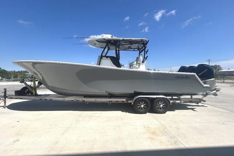 Slide: The Image of 2022 Onslow Bay 33 Tournament boat on trailer under clear blue sky. - 3