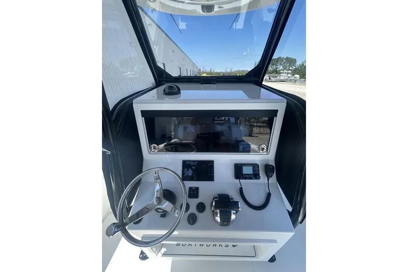 Slide: The Image of 2022 Onslow Bay 33 Tournament boat console with steering wheel and navigation controls. - 6