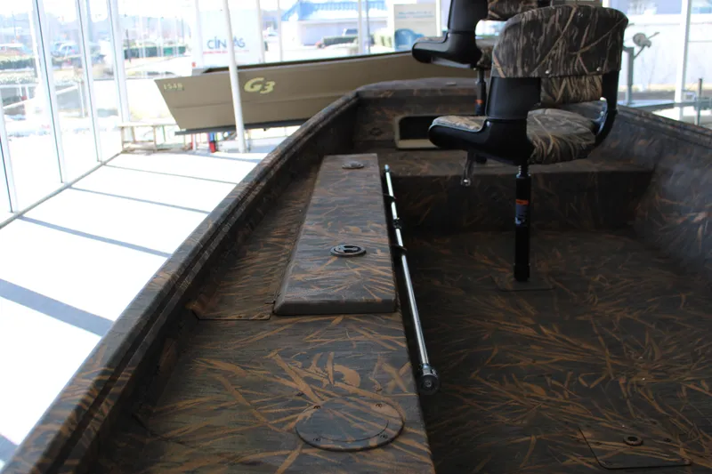 Slide: The Image of 2025 G3 Gator Tough 16 DK boat interior with camo seats and flooring. - 11