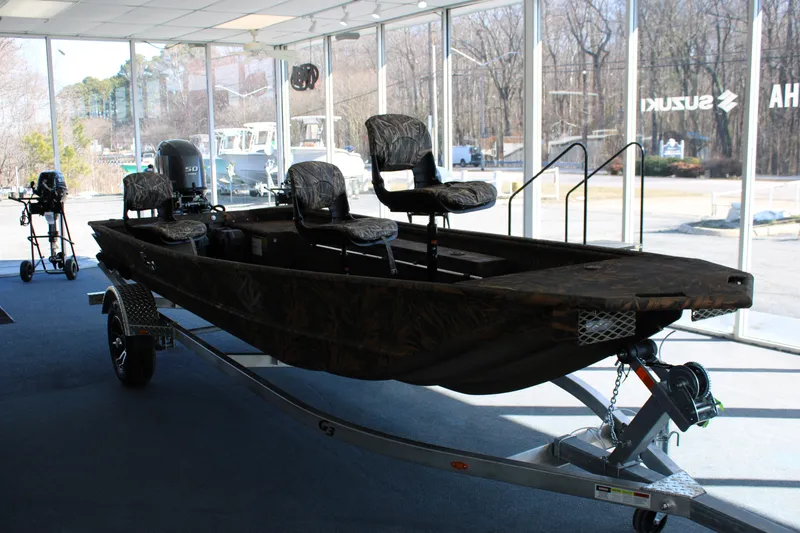 Slide: The Image of 2025 G3 Gator Tough 16 DK boat on trailer in showroom. - 2