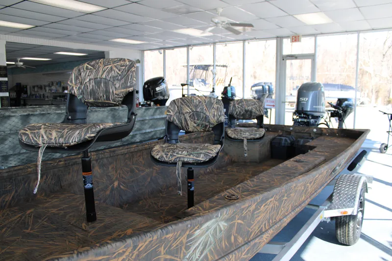 Slide: The Image of 2025 G3 Gator Tough 16 DK boat with camo seats in showroom. - 4