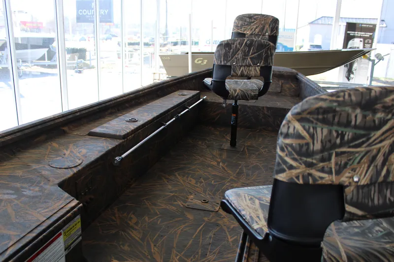 Slide: The Image of 2025 G3 Gator Tough 16 DK boat interior with camo seats and flooring. - 8