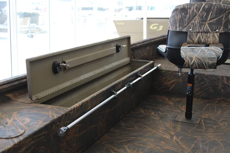 Slide: The Image of 2025 G3 Gator Tough 16 DK boat interior with camo seating and storage compartment. - 9