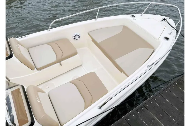 Slide: The Image of Manufacturer Provided Image: 2025 Scout 175 Sport Dorado boat interior with beige seating, docked on water. - 20