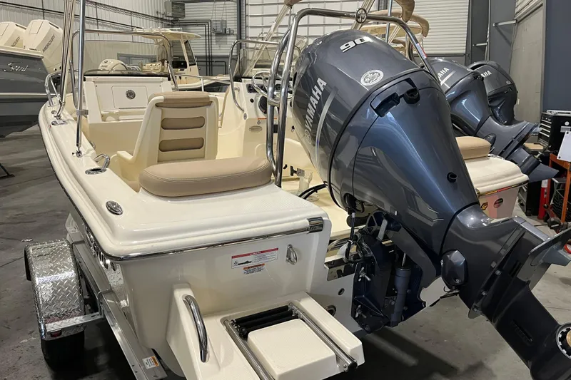 Slide: The Image of 2025 Scout 175 Sport Dorado boat with Yamaha outboard motor in a showroom. - 3