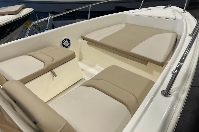 Slide: The Image of 2025 Scout 175 Sport Dorado boat interior with beige seating and stainless steel railings. - 8
