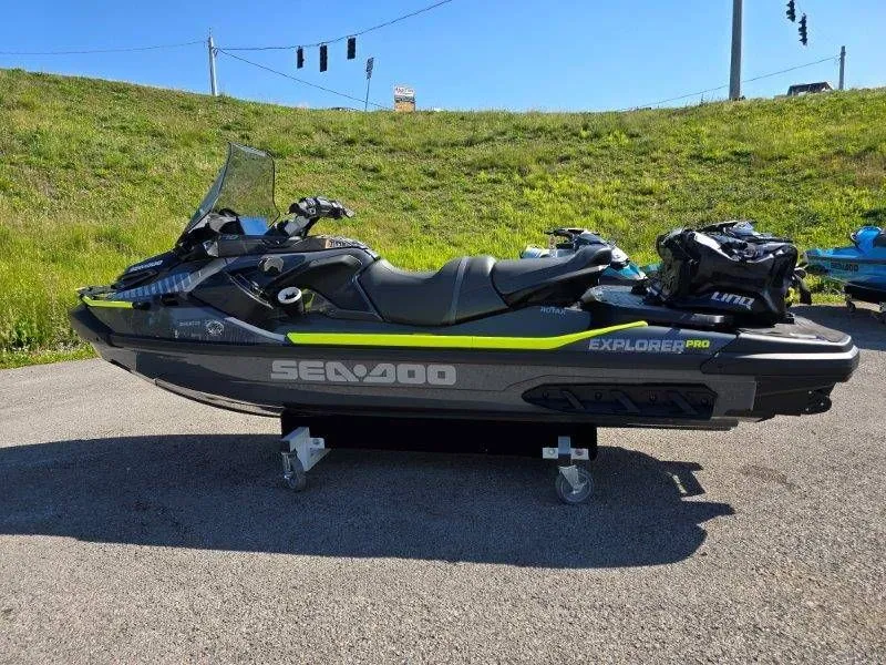 Slide: The Image of 2026 Sea-Doo Explorer Pro 170 jet ski on pavement with grassy hill backdrop. - 16