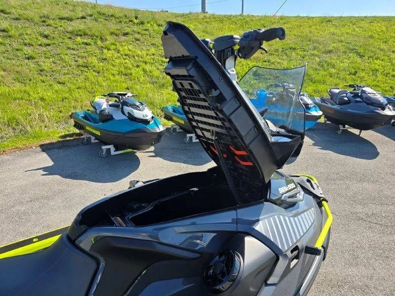 Slide: The Image of 2026 Sea-Doo Explorer Pro 170 with open storage lid on parking lot. - 27