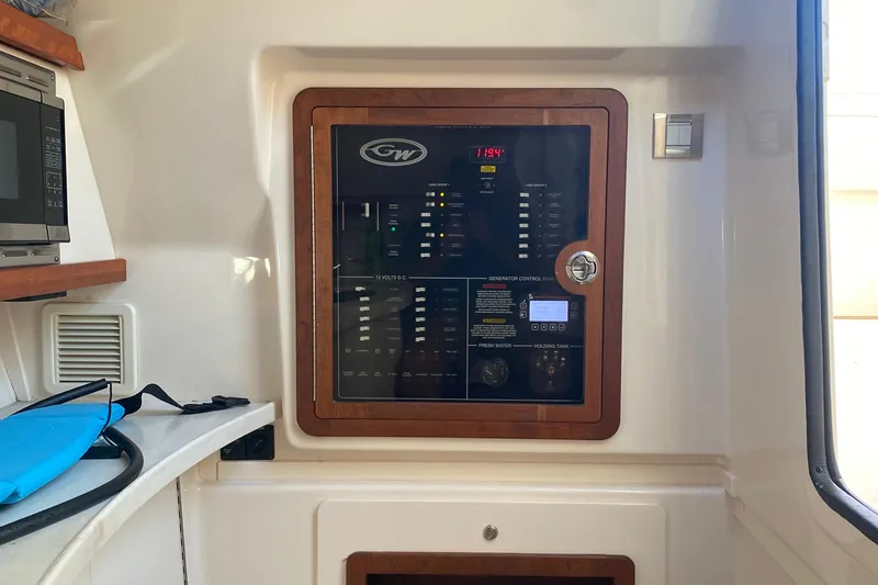 Slide: The Image of 2024 Grady-White Freedom 375 control panel with microwave and storage area. - 14