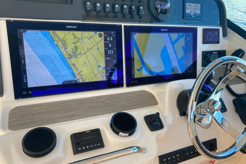 Slide: The Image of Control panel of 2024 Grady-White Freedom 375 with dual Simrad displays. - 16