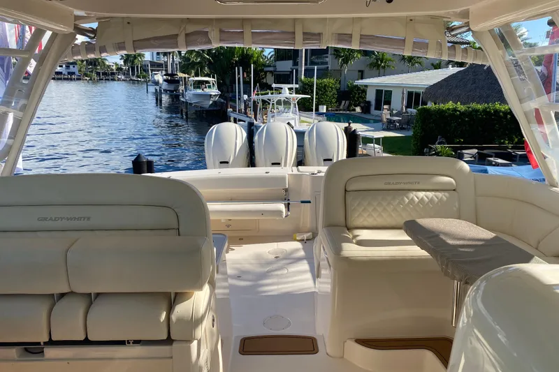 Slide: The Image of 2024 Grady-White Freedom 375 boat interior with luxurious seating and waterfront view. - 20