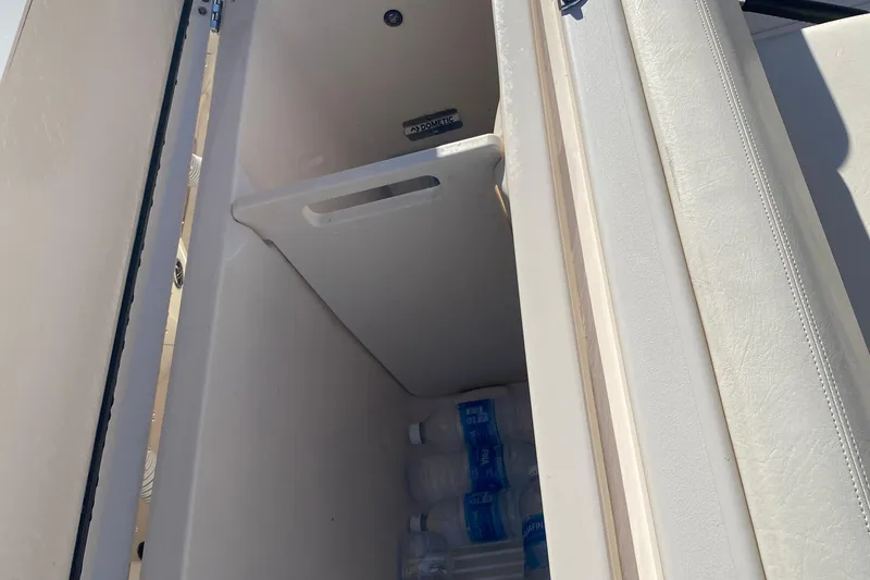 Slide: The Image of Storage compartment with water bottles on a 2024 Grady-White Freedom 375 boat. - 24
