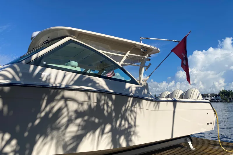 Slide: The Image of 2024 Grady-White Freedom 375 boat docked under clear blue sky. - 5