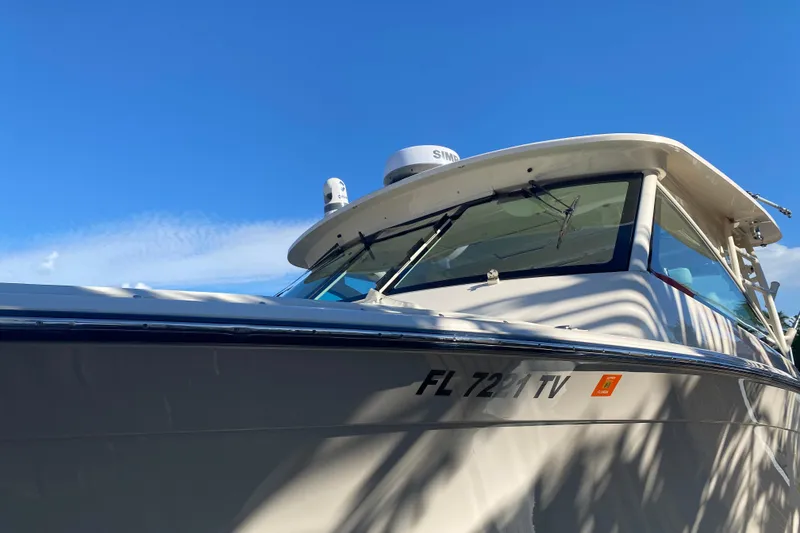 Slide: The Image of 2024 Grady-White Freedom 375 boat under clear blue sky. - 6