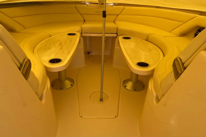 Slide: The Image of 2024 Grady-White Freedom 375 boat interior with cushioned seating and dual tables. - 7