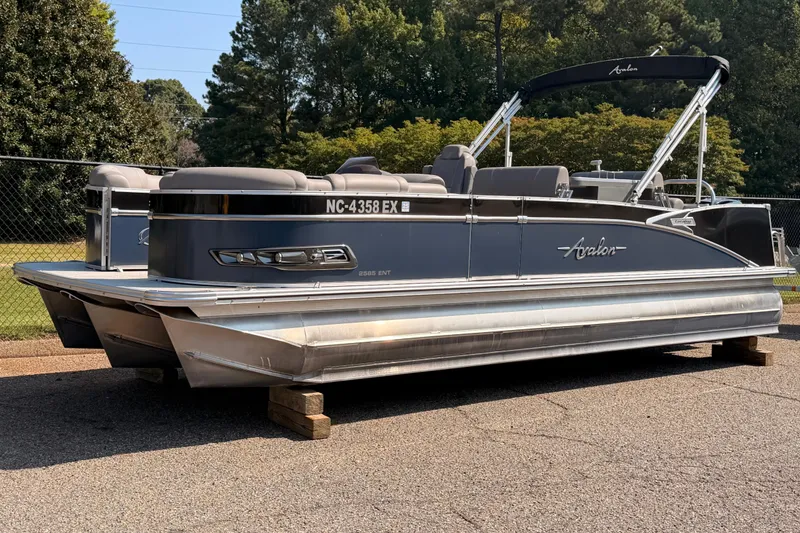 Slide: The Image of 2022 Avalon 2585 ENT Catalina Platinum pontoon boat on display outdoors. - 1