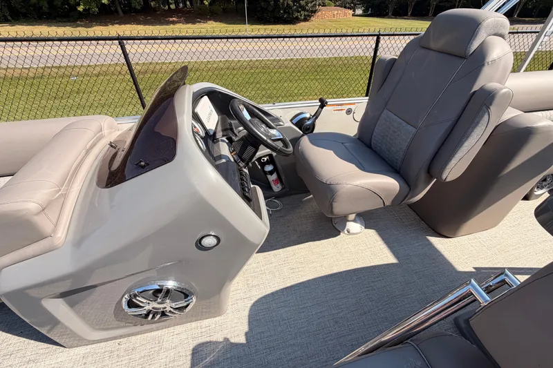 Slide: The Image of 2022 Avalon 2585 ENT Catalina Platinum boat interior with steering console and plush seating. - 11