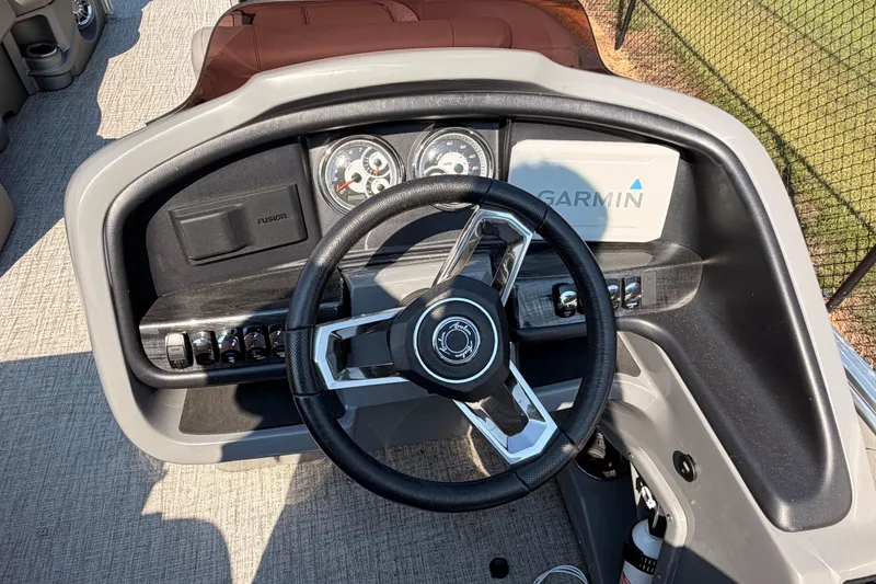 Slide: The Image of 2022 Avalon 2585 ENT Catalina Platinum dashboard with steering wheel and Garmin display. - 12