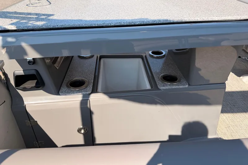 Slide: The Image of 2022 Avalon 2585 ENT Catalina Platinum boat interior with cup holders and storage. - 18