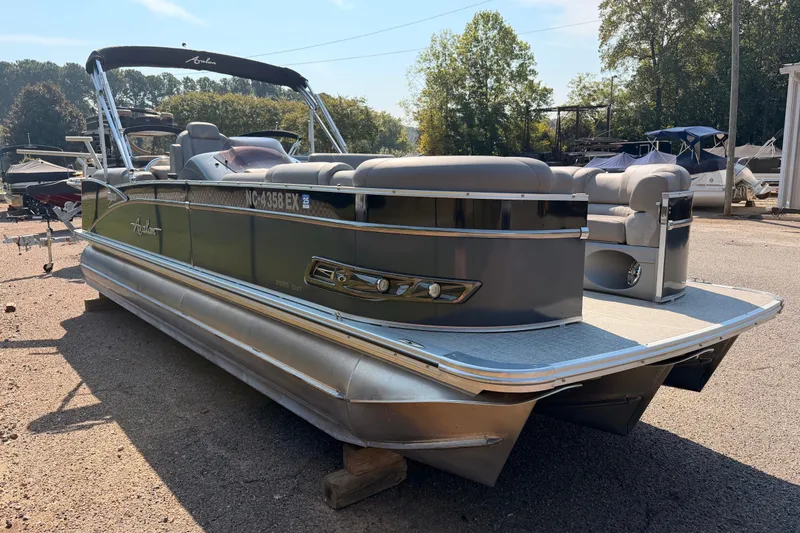 Slide: The Image of 2022 Avalon 2585 ENT Catalina Platinum pontoon boat parked outdoors. - 3