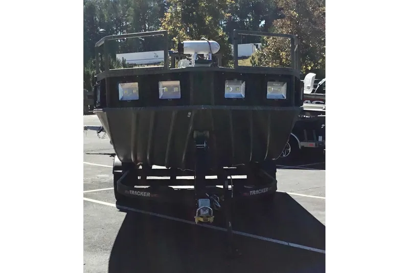 The Image of 2023 Tracker Grizzly 2072 CC Sportsman boat on trailer in parking lot. - 0