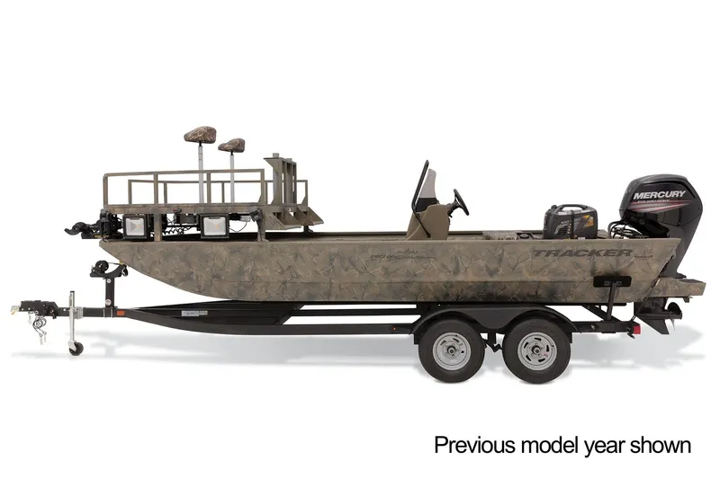 Slide: The Image of 2023 Tracker Grizzly 2072 CC Sportsman boat on trailer in parking lot. - 2