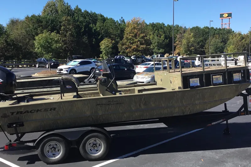 Slide: The Image of 2023 Tracker Grizzly 2072 CC Sportsman boat on trailer in parking lot. - 6