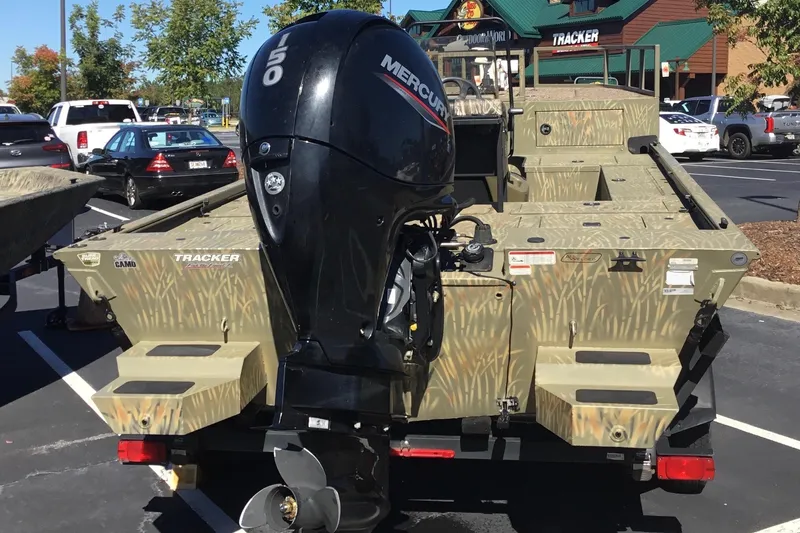 Slide: The Image of 2023 Tracker Grizzly 2072 CC Sportsman boat with Mercury outboard motor in parking lot. - 7