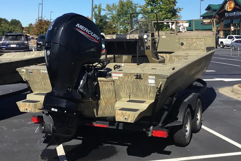 Slide: The Image of 2023 Tracker Grizzly 2072 CC Sportsman boat with Mercury outboard motor in parking lot. - 8