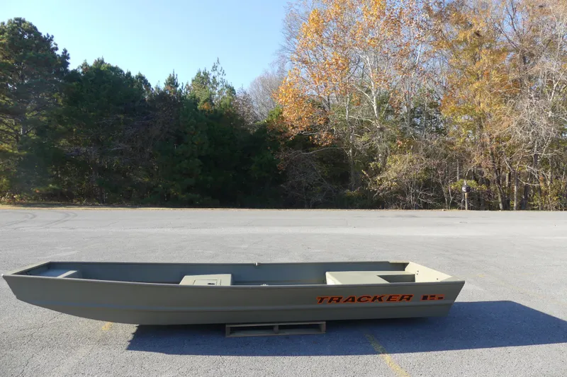 The Image of 2026 Tracker Grizzly 15 Jon boat in parking lot, surrounded by autumn trees. - 0